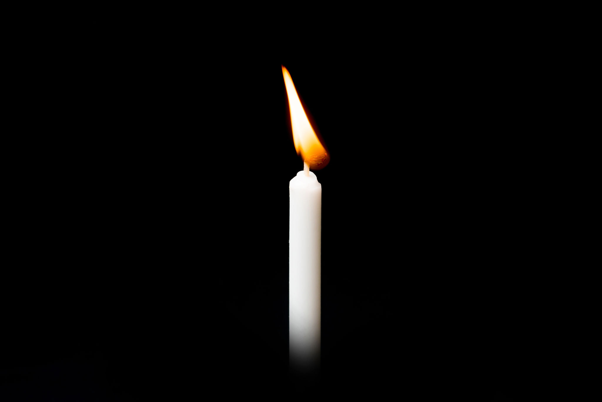 A lit candle in the dark
